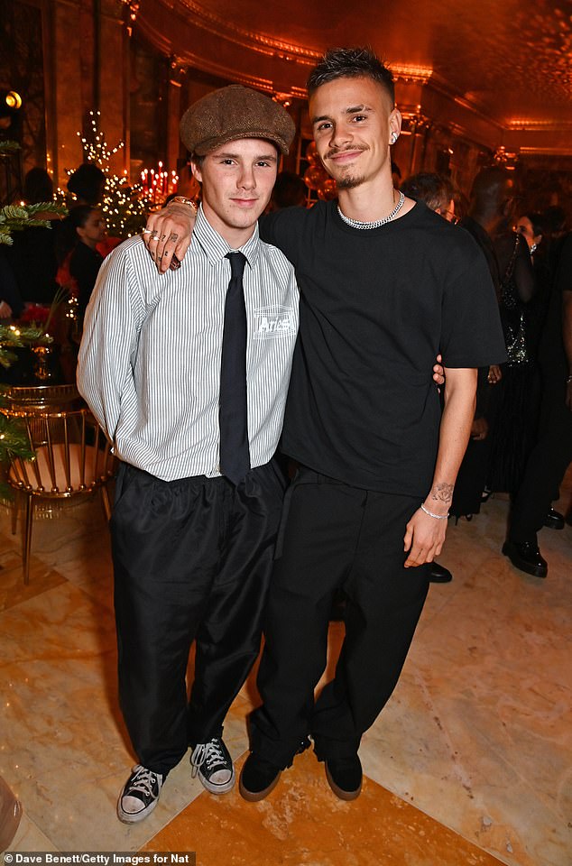 Romeo Beckham seemed in high spirits as he hit the star-studded British Fashion Awards party at Aberconway House with younger brother Cruz, (left) and girlfriend Mia Regan on Monday night