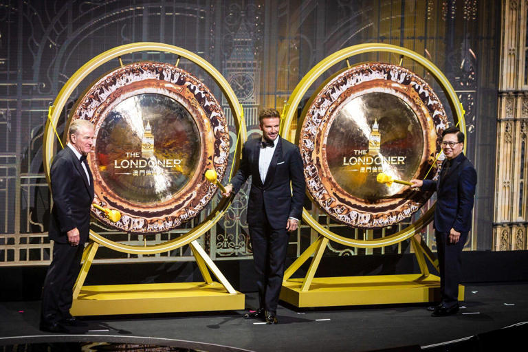 Robert Goldstein, chairman and chief executive officer of Las Vegas Sands Corp. and Sands China Ltd., left, David Beckham, former football star, centre, and Wilfred Wong, president of Las Vegas Sands Corp. and Sands China Ltd., prepare to beat the gong during the opening ceremony at the Londoner Macau casino resort, on May 25. Photo: Bloomberg