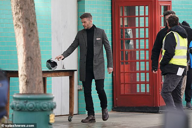 job done:  Beckham appeared to discard his baseball during a break between scenes on Tuesday 