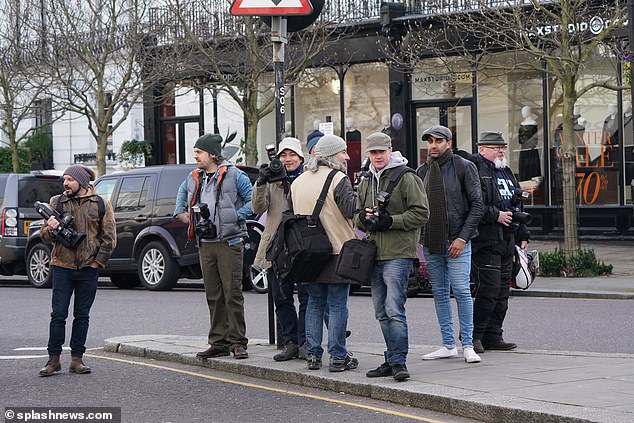 Where's Becks? Meanwhile a group of photographers armed with long-lens cameras lingered nearby