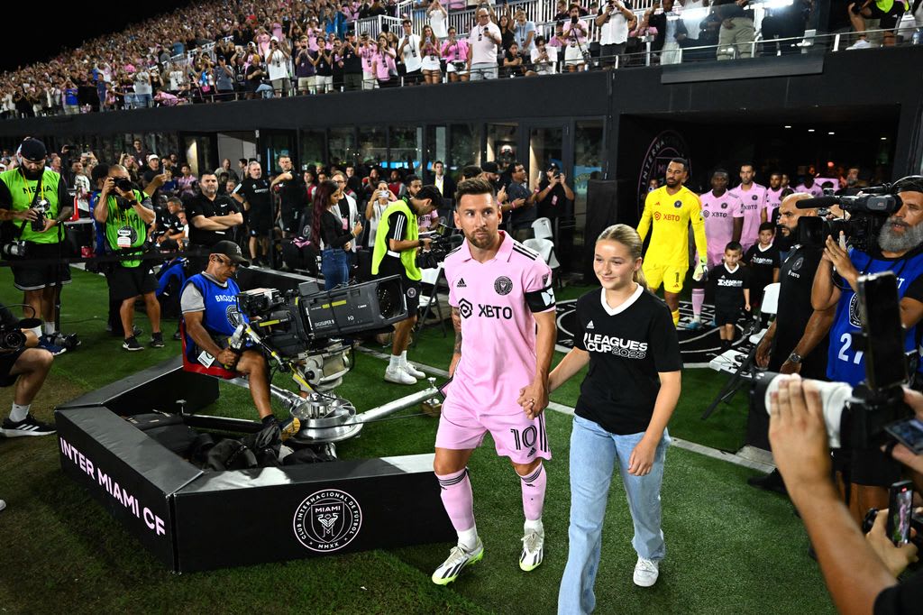 Harper walking hand-in-hand with lionel messi 