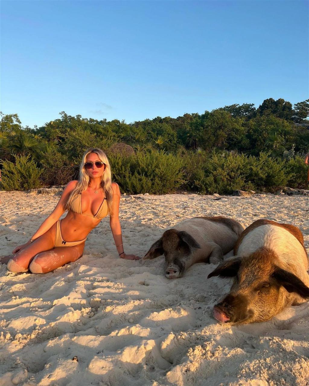 Alix Earle poses on pig beach in a bikini