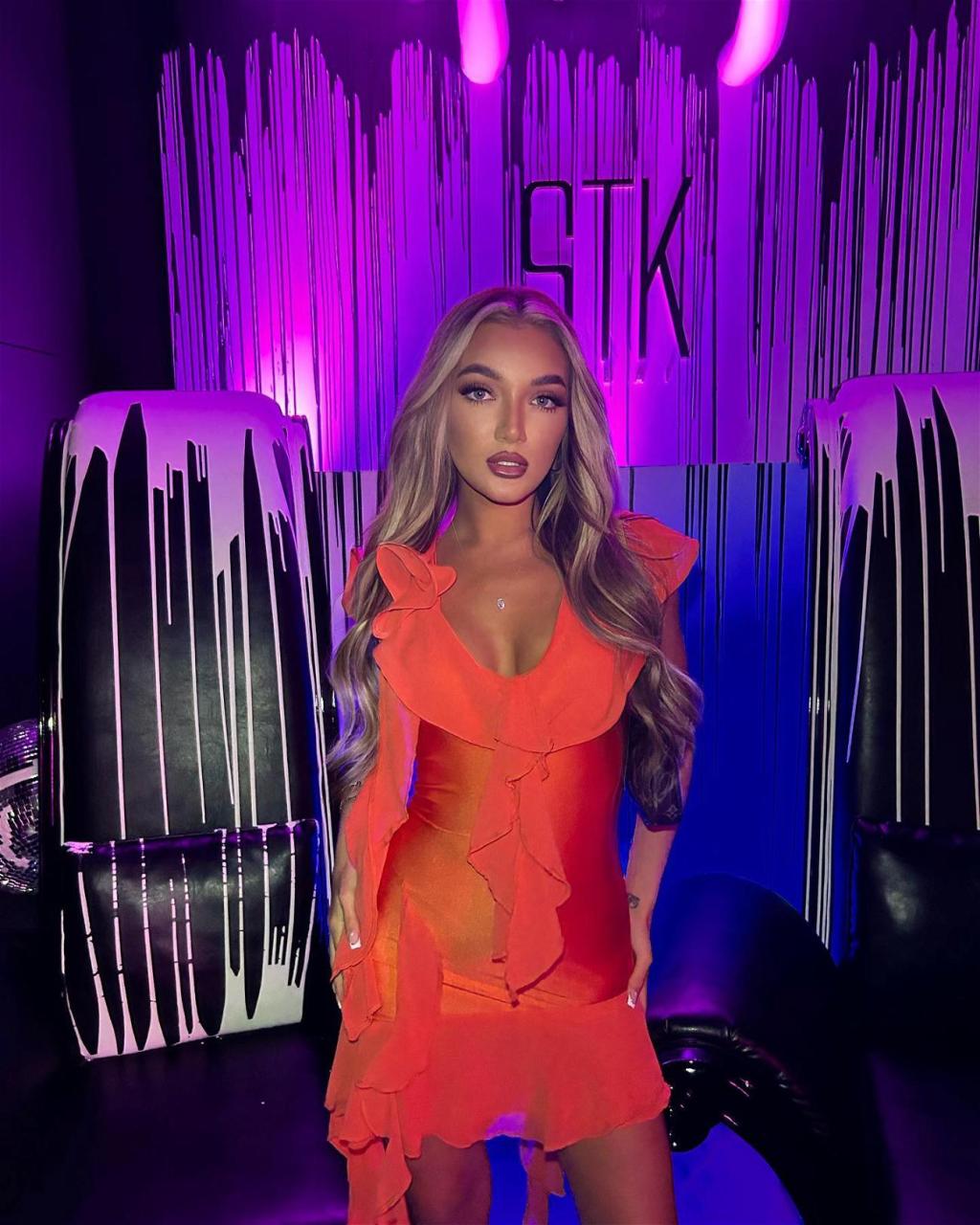 Beaux Raymond in an orange dress