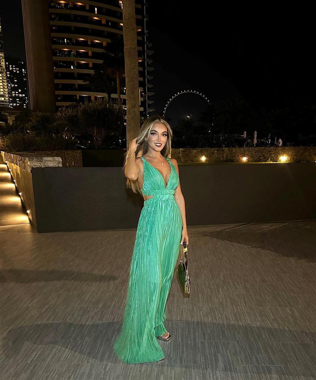 Beaux Raymond poses in a green gown