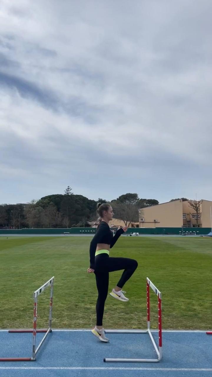 Clara Fernandez running over hurdles