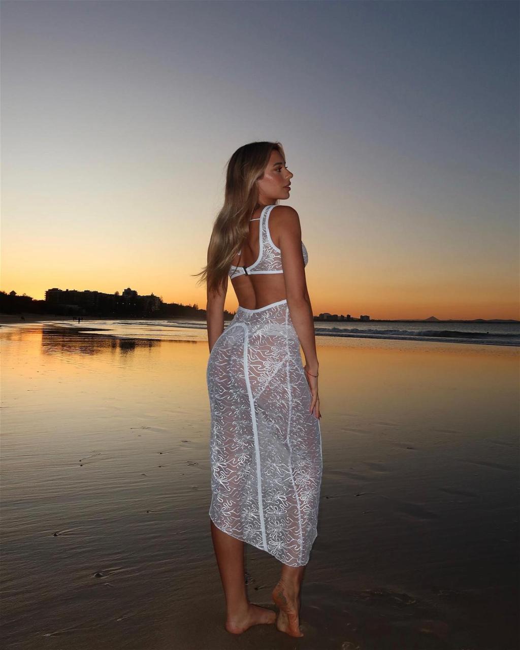 Georgia Hassarati Hits The Beach At Sunset In A See-Through Dress