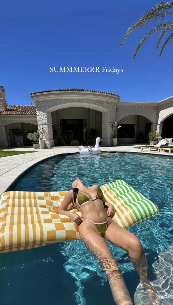 Atiana De La Hoya basks in the sun while lounging on a pool floatie in her olive green bikini.