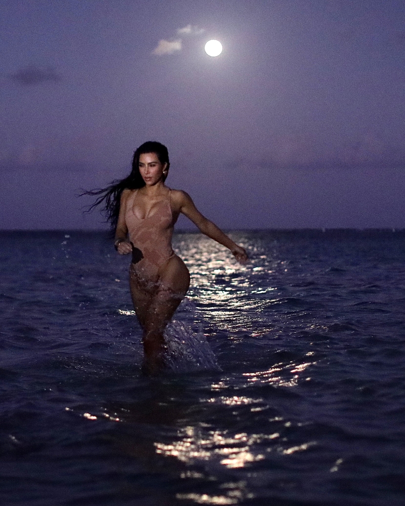 Kim Kardashian Flaunts Curves in Black Bikini and Nude One-Piece for Skims Swim Photo Shoot