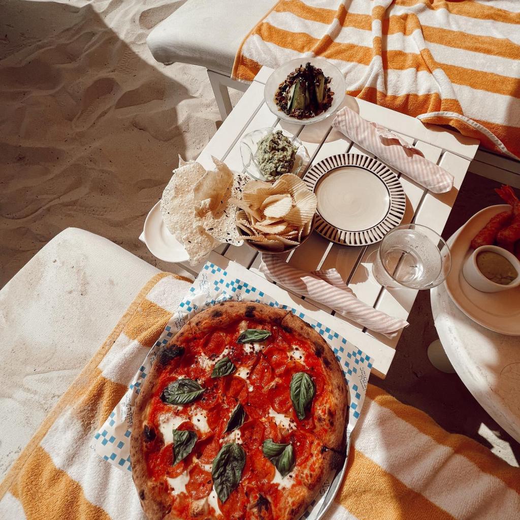 A pizza on the beach. 