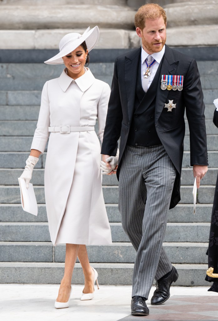 Meghan Markle and Prince Harry walking down steps of cathedral