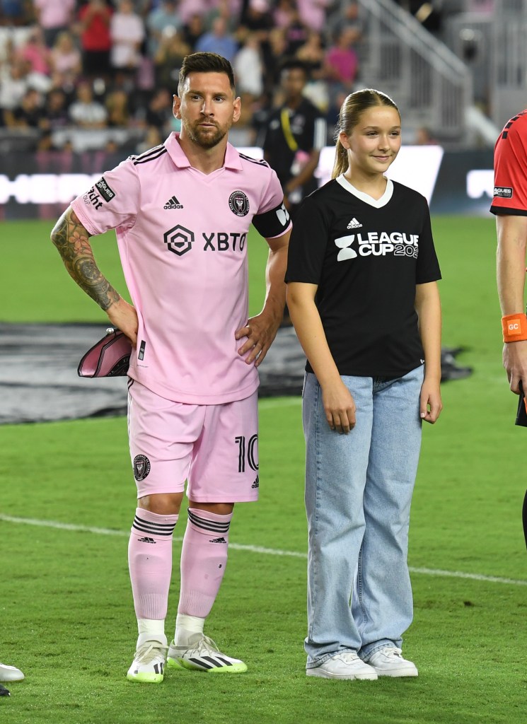 lionel messi and harper beckham standing on the soccer pitch