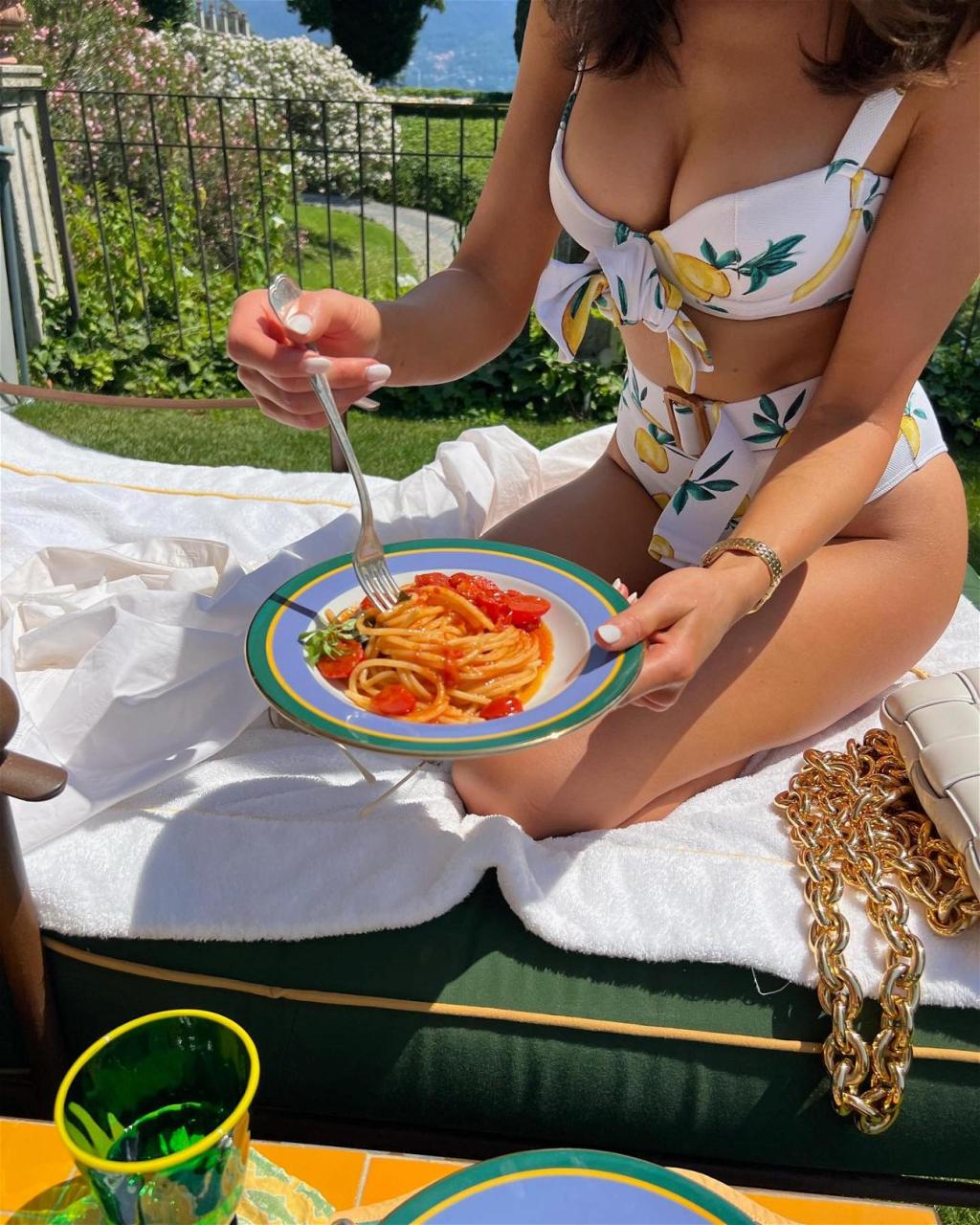 Olivia Culpo Enjoys A Plate Of Pasta In Her Lemon-Print Bikini