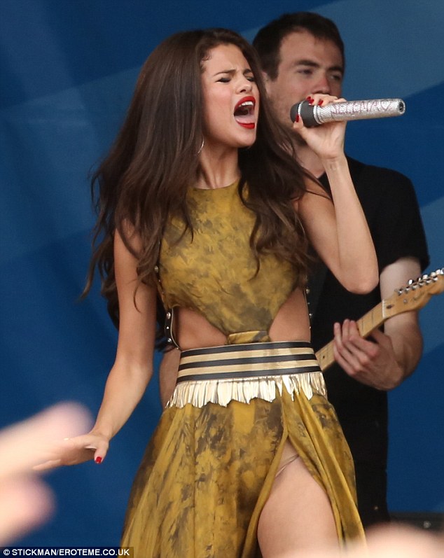 Oops again: Selena's flesh-hued underwear was showing again as her dress parted in the middle