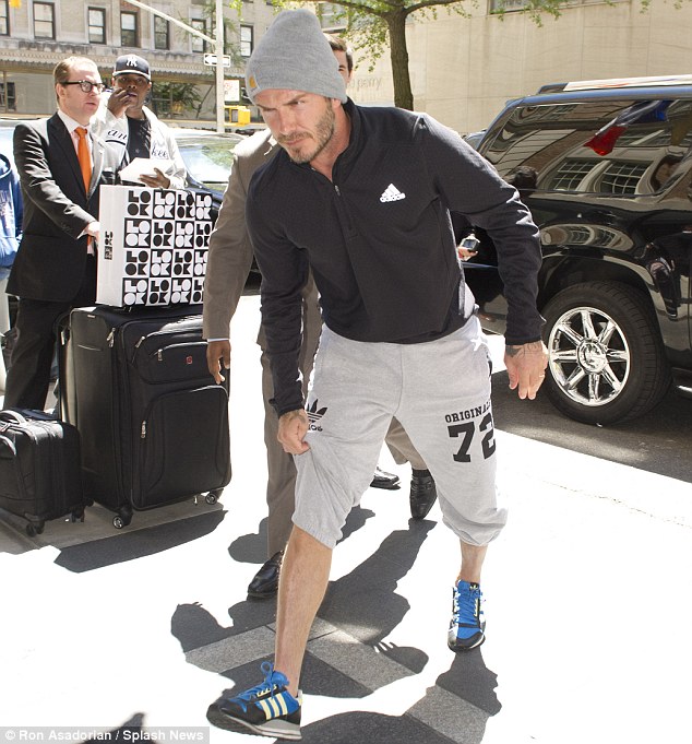 Sports star: Earlier in the day, David was seen returning to his hotel in an Adidas tracksuit, wooly hat and trainers