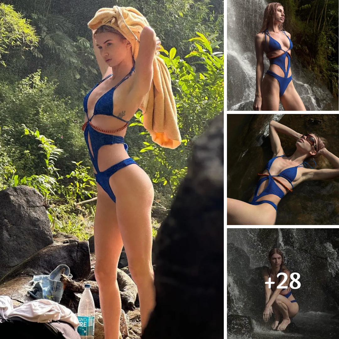 Brittan Byrd Steps Under A Waterfall In A Cut-Out Blue Swimsuit