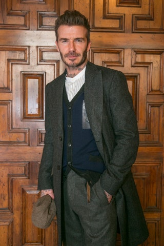 Image may contain David Beckham Clothing Apparel Coat Overcoat Suit Human Person and Wood