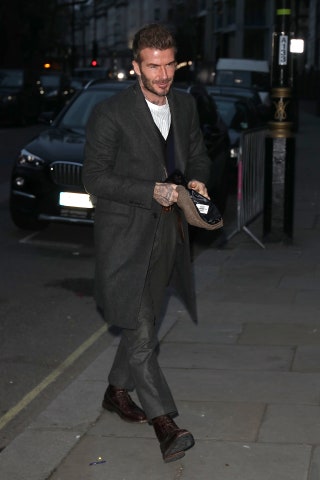 Image may contain David Beckham Clothing Apparel Footwear Shoe Coat Overcoat Human Person and Vehicle