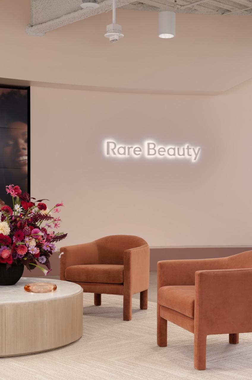 A pair of West Elm armchairs in performance velvet sit in the Rare Beauty lobby.