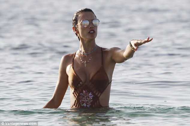 Sassy: The star turned heads with her sensational physique as she swam along 