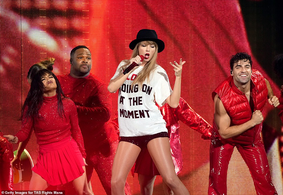 Low key: Taylor dressed down for an upbeat number in which she wore a white graphic T-shirt and sequined shorts with a black fedora