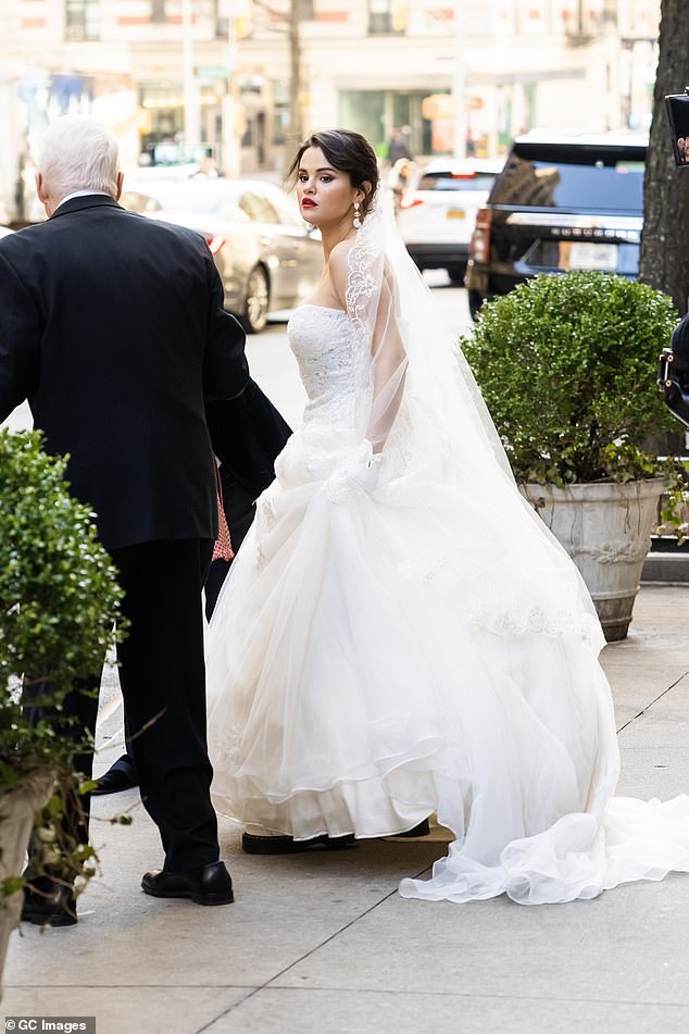 Edgy: For an edgy touch, Selena paired her glamorous wedding dress with white platform combat boots