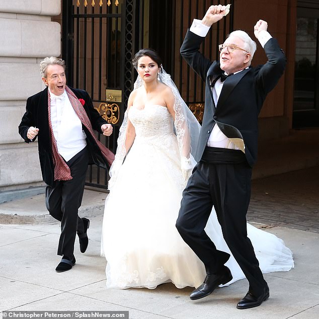 Dressed to the nines: Martin Short rocked a black suede coat styled with black slacks and a red knit scarf